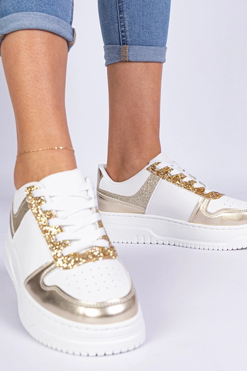 Goldene Damensneaker auf...