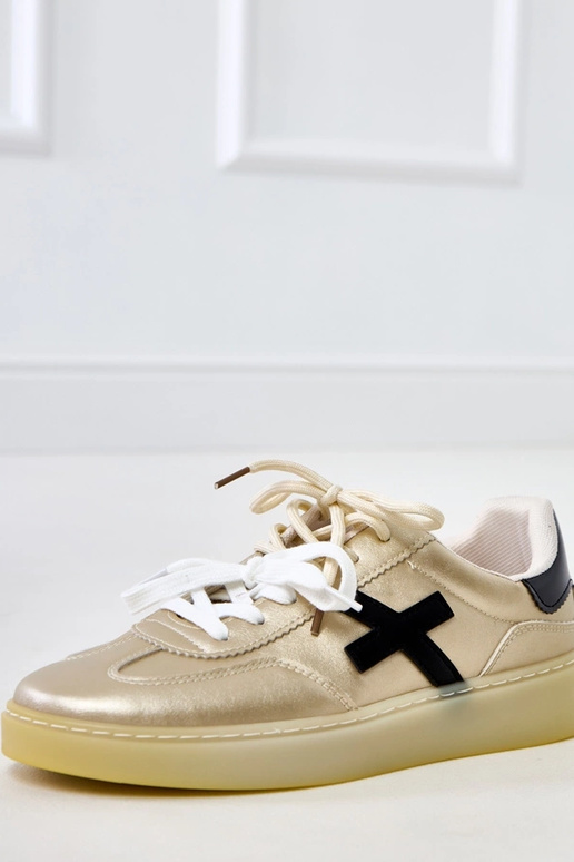 Goldene Sneakers auf Plattform mit... Goldene Sneakers auf Plattform mit...