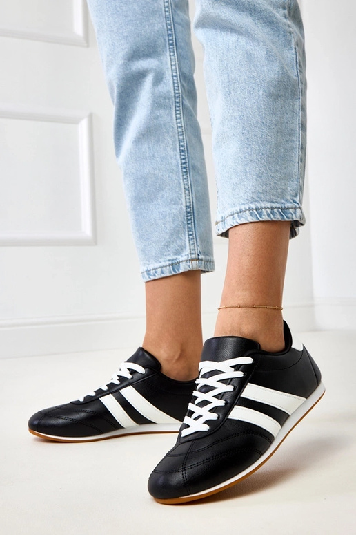 Schwarze Tennisschuhe mit weißem... Schwarze Tennisschuhe mit weißem...