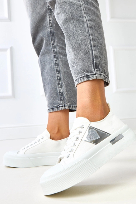 Weiße Sportpantoletten auf Plattform...