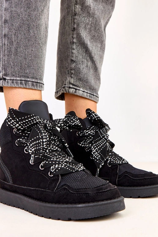 Schwarze hohe Sportschuhe mit dicken... Schwarze hohe Sportschuhe mit dicken...