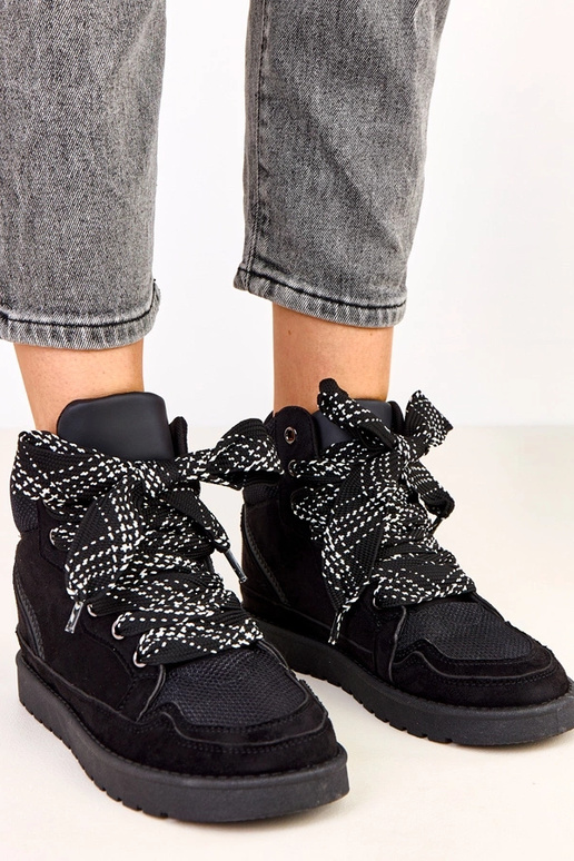 Schwarze hohe Sportschuhe mit dicken... Schwarze hohe Sportschuhe mit dicken...